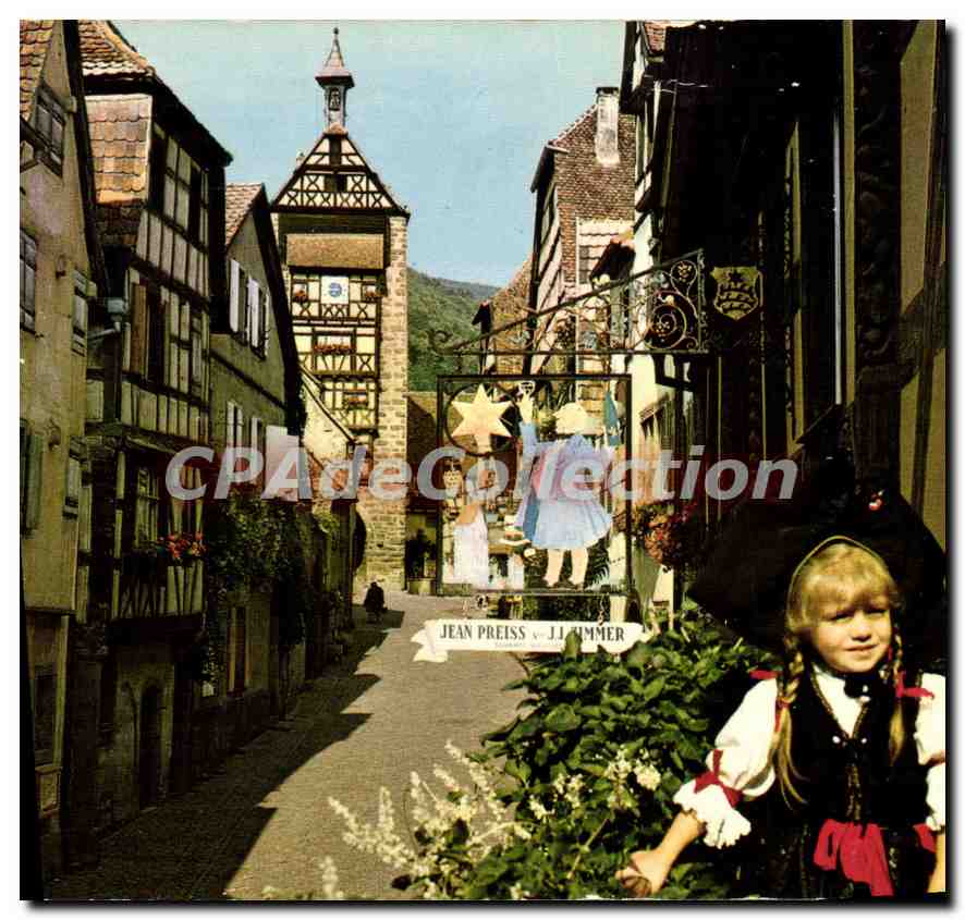 Riquewihr — rue pavée avec tour et vitrine de Jean Preiss — Jean Preiss & JJ Timmer - Anverso
