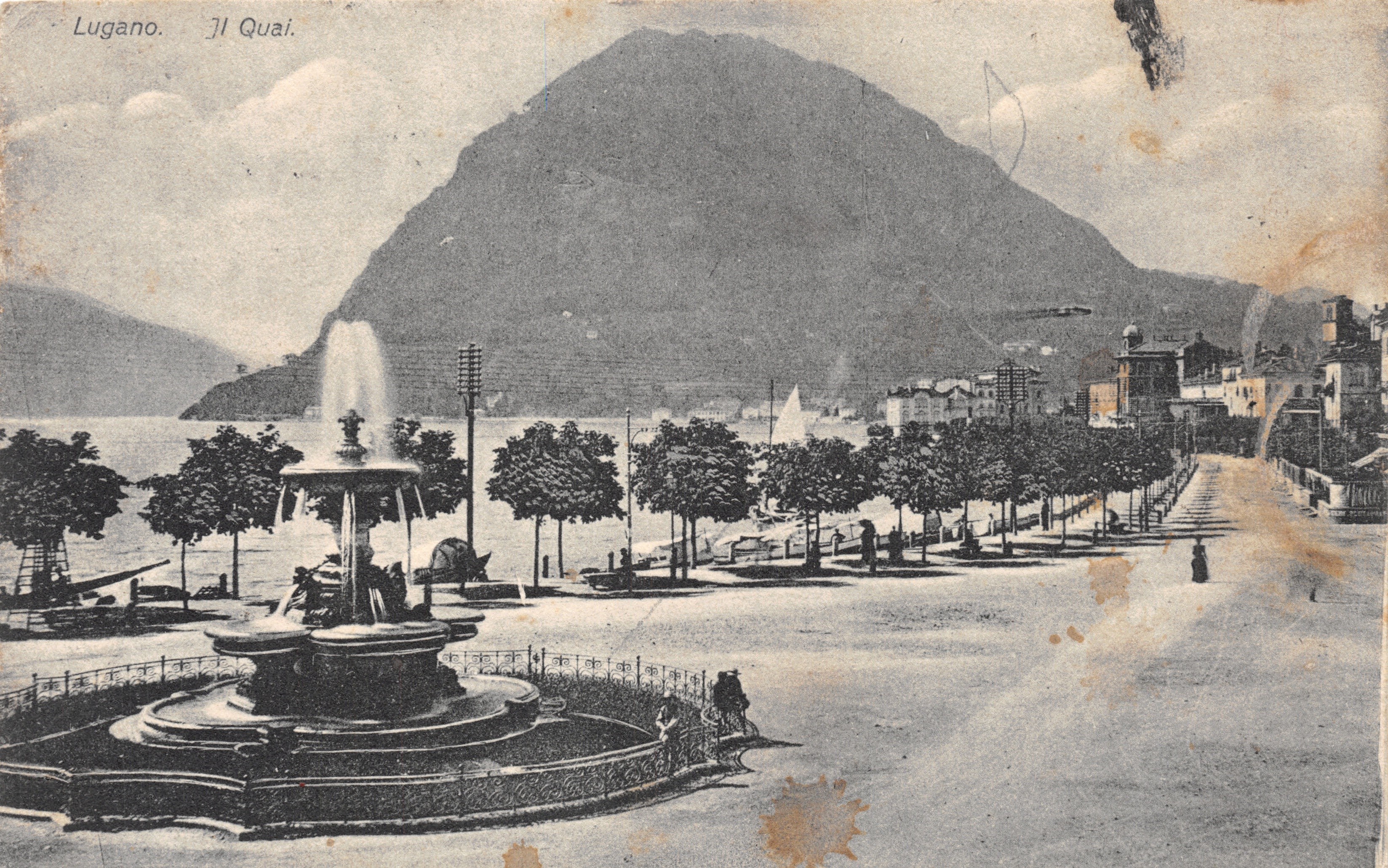 Lugano — El Quai con fuente y montaña en primer plano — A.G. Grill, Lugano