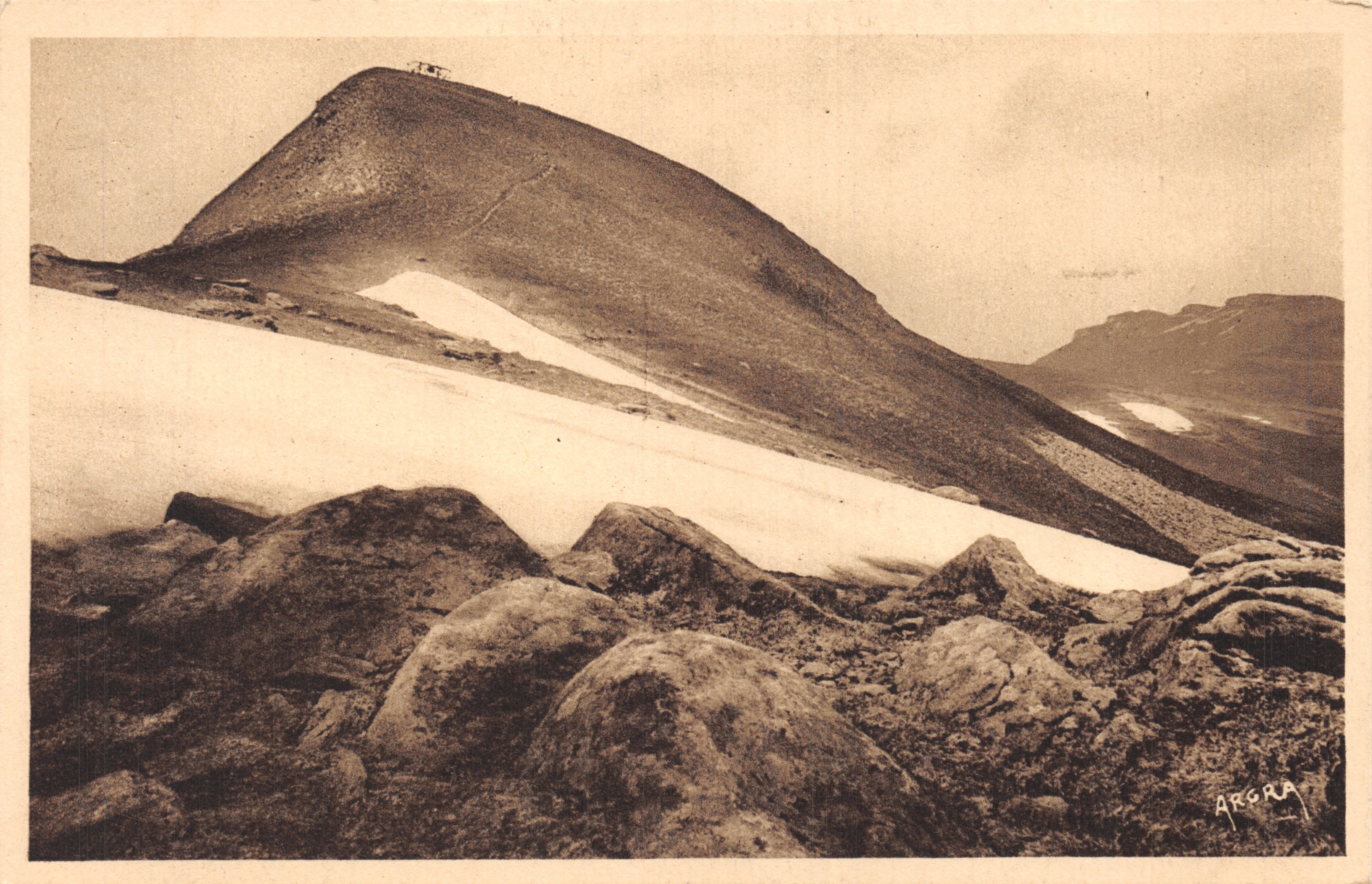The Plomb du Cantal — snow-covered summit with rocks in the foreground — publisher ARORA