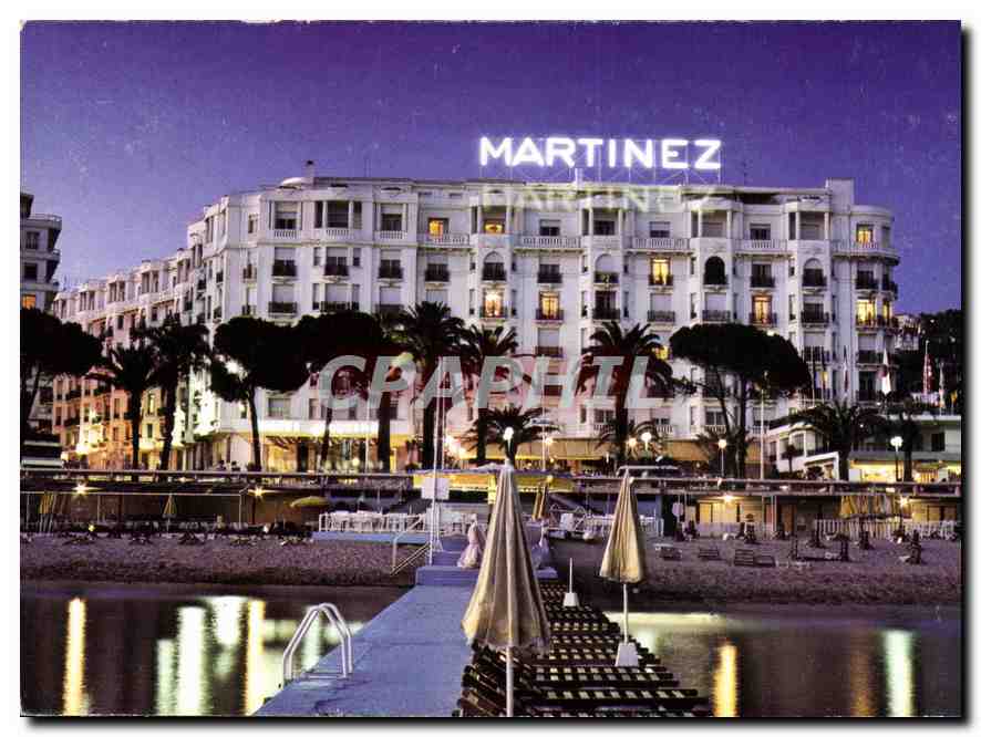 CPM Cannes Alpes Maritimes Sur la Croisette et en debut de soiree l'Hotel Martinez 