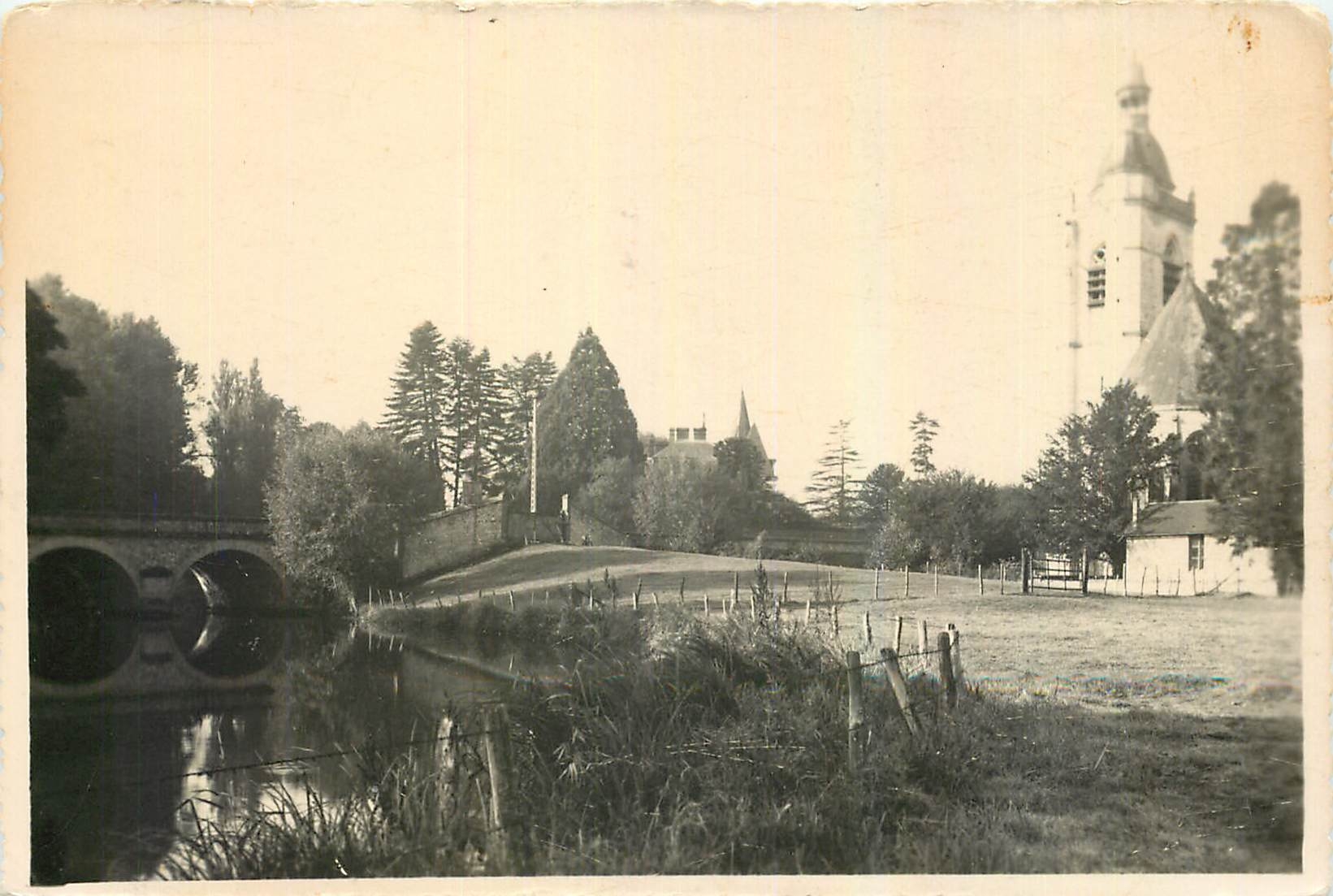 CPA Nogent le Rotrou E & L Le Pont et L'Eglise St Hilaire vue sur l'Huisne 