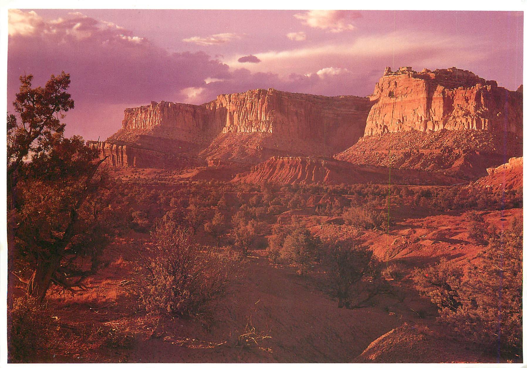 CPM Late light adds drama to the striking formations topped by the great wingate sandstone cliffs ti