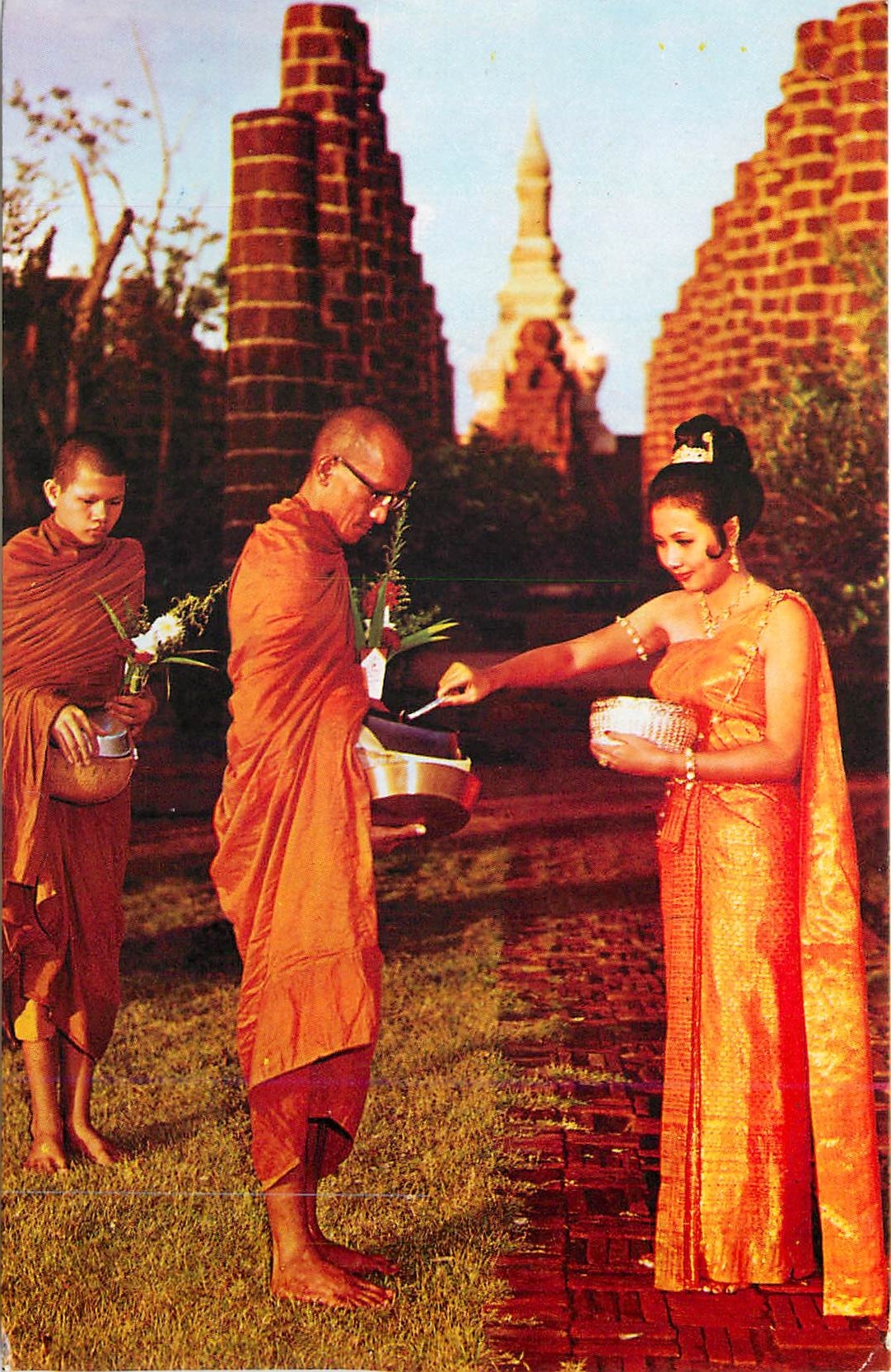 CPM A Thai Young girl is making merit by giving foods to the priest