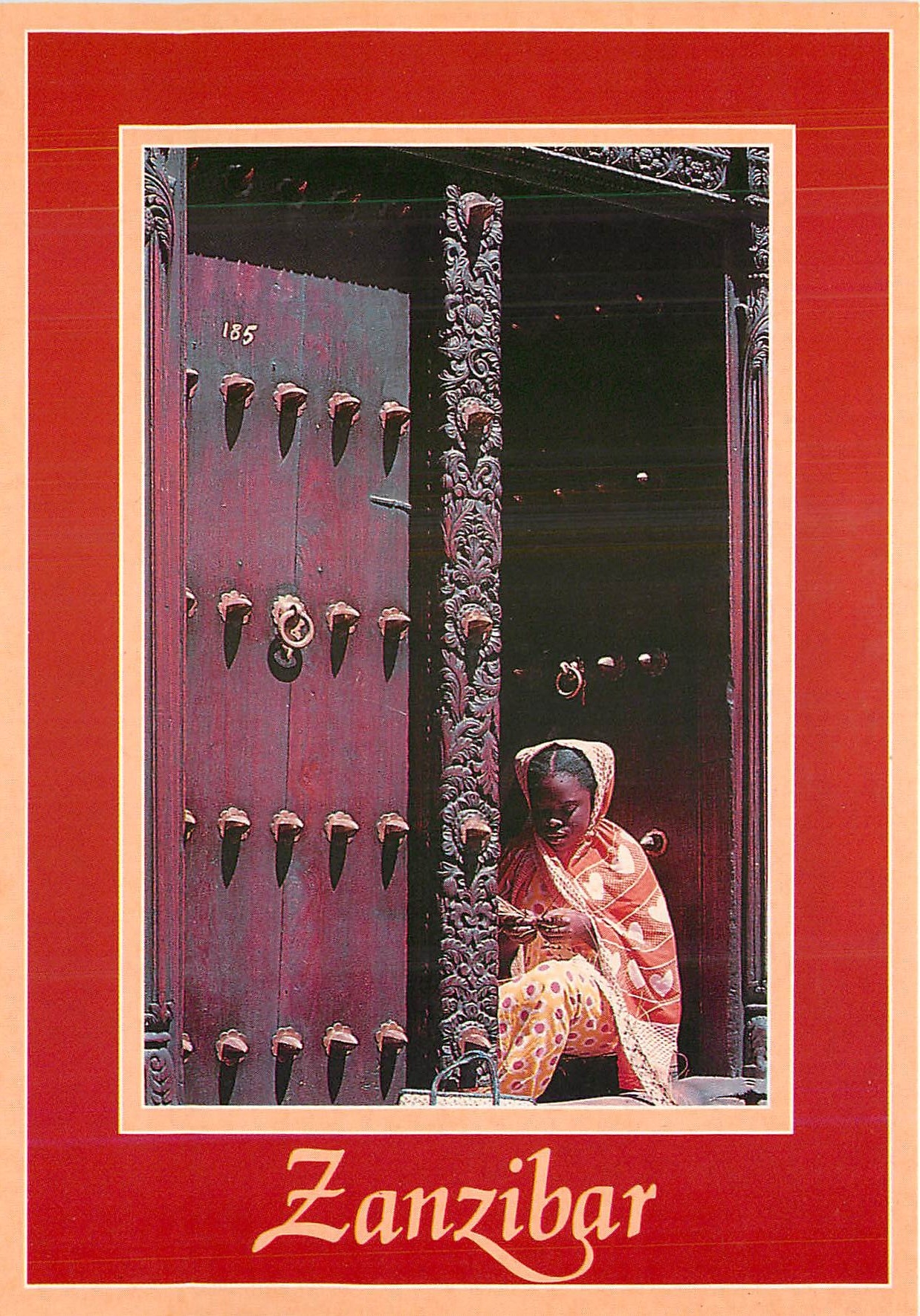 CPM Zanzibar A young girl plaiting by an antique carved door 