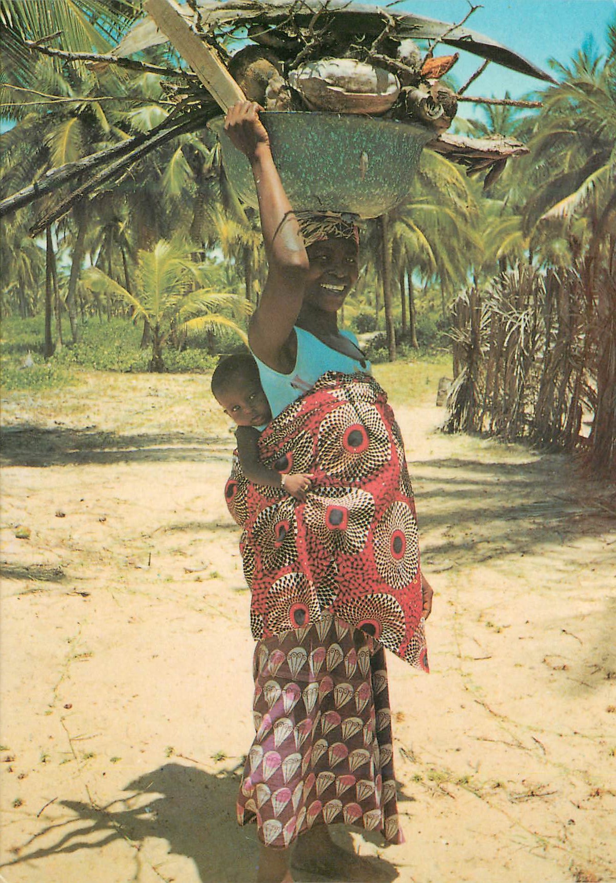 CPM Woman with child carrying fire wood 