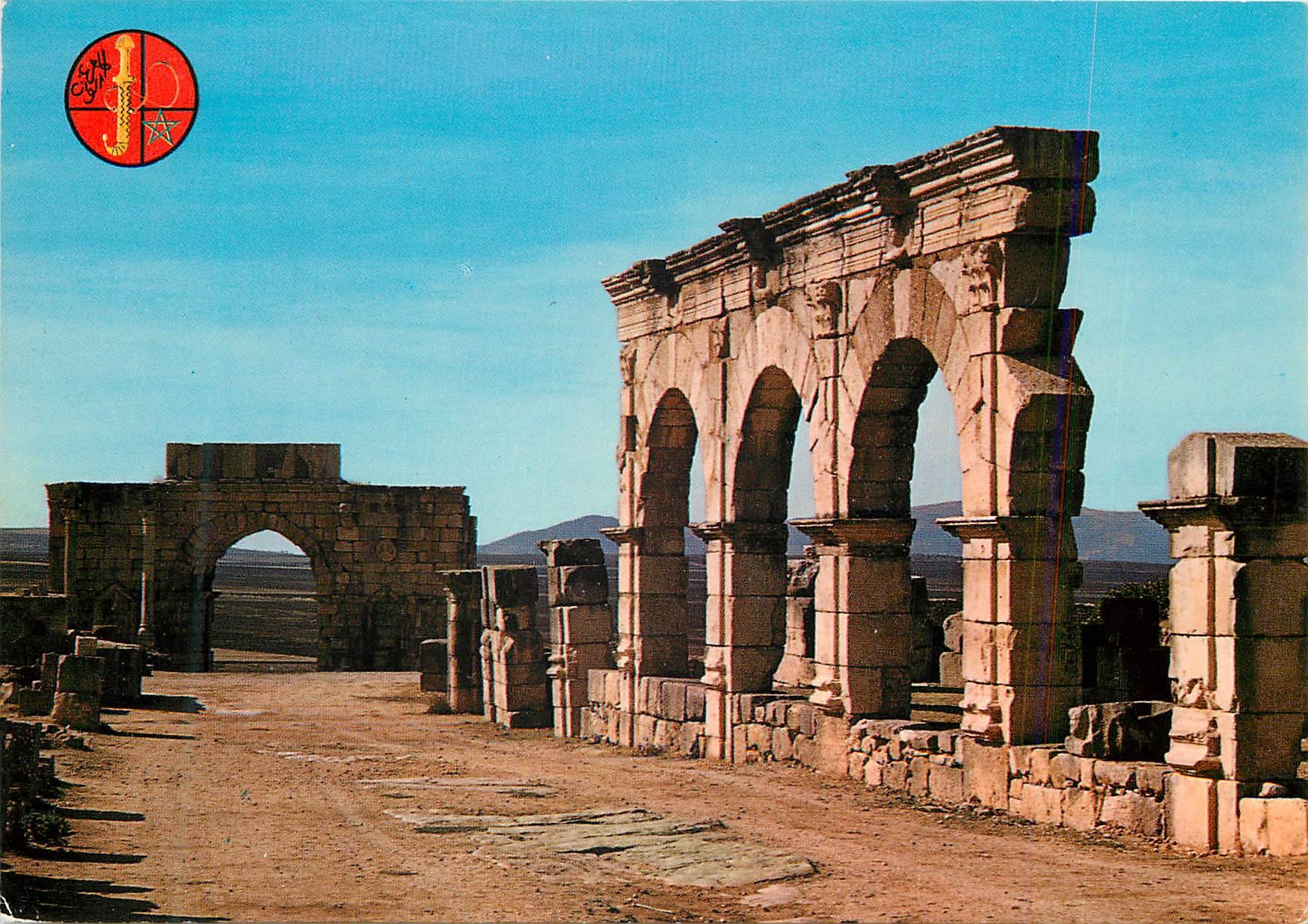 CPM Volubilis Portique et Arc de Triomphe vus du decomanus maximus 