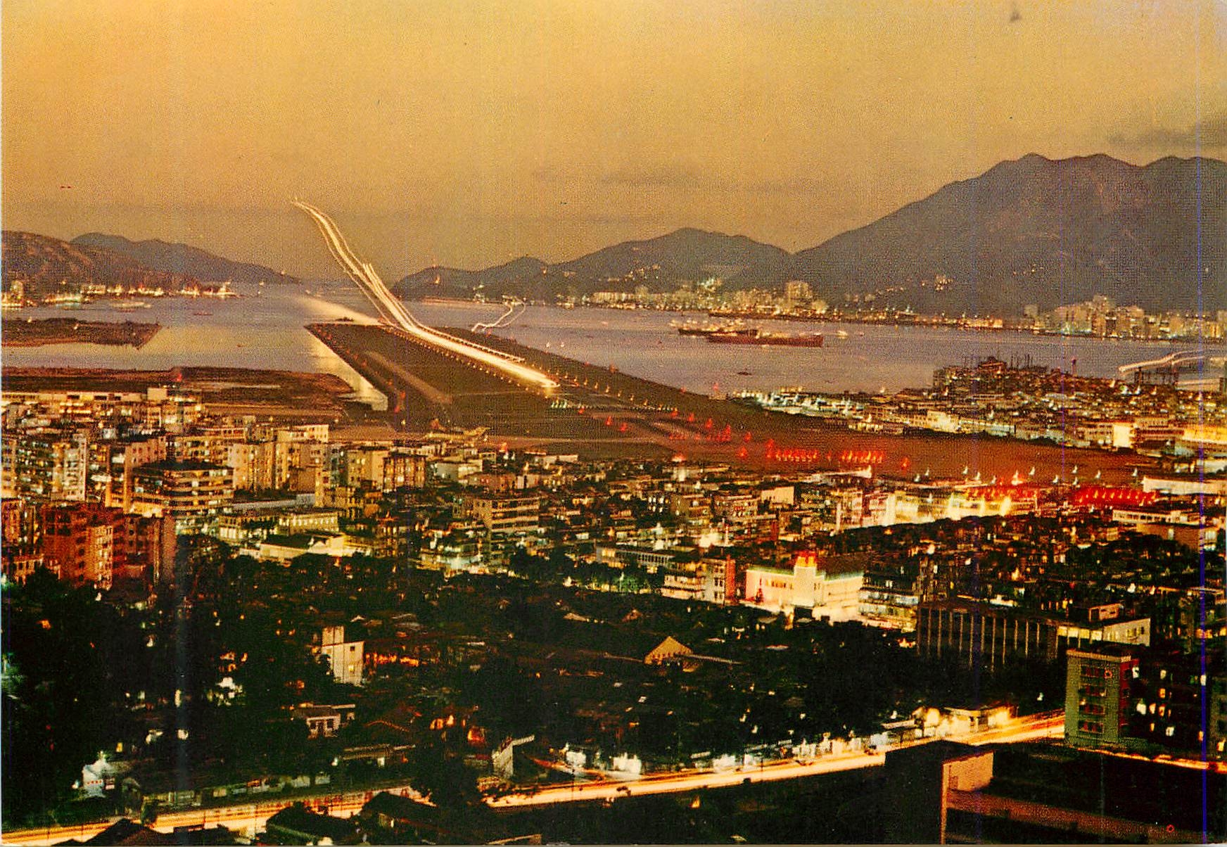 CPM Hong Kong view of plane making a night banding at Kaitak