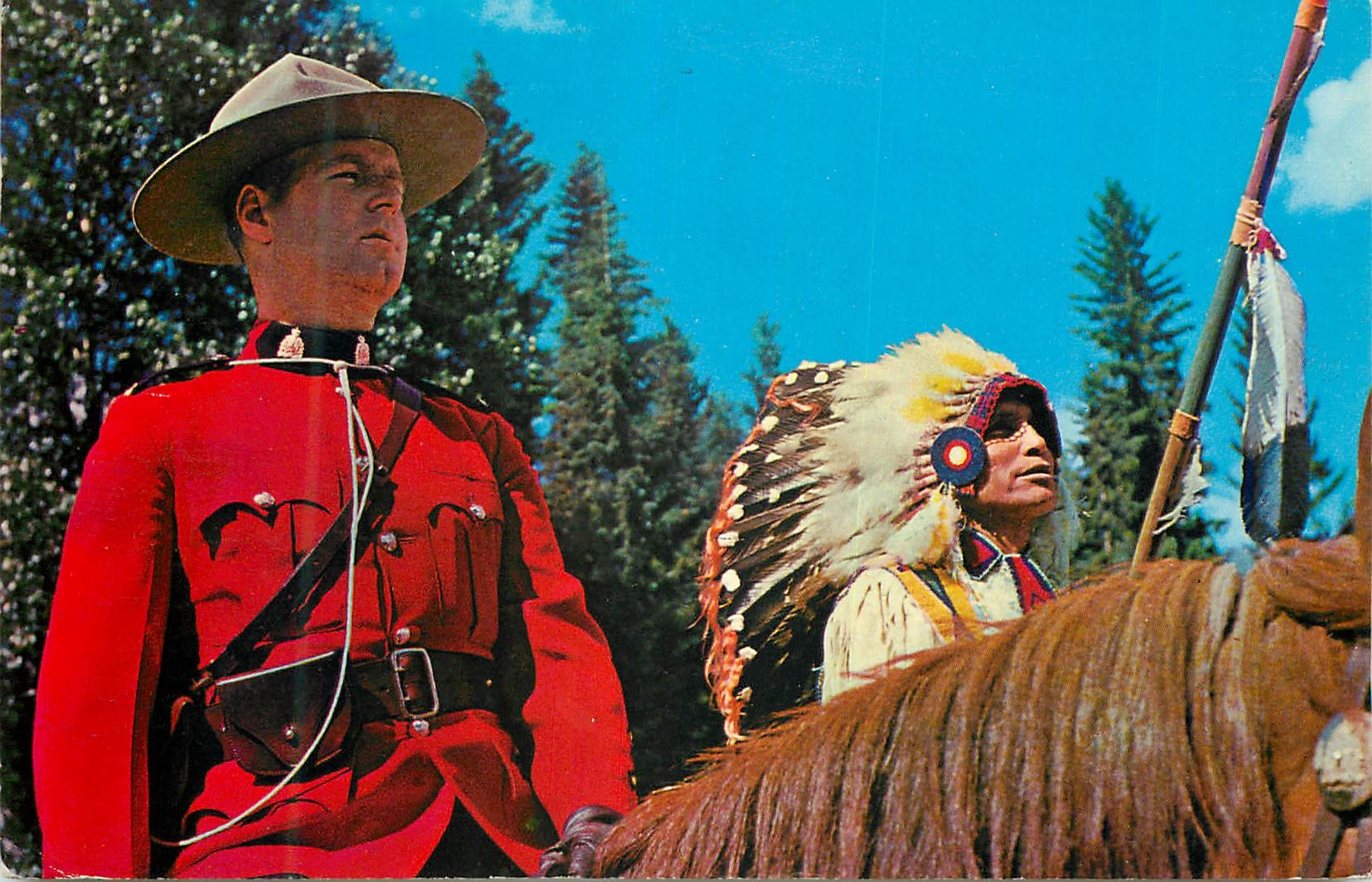 CPM Canada An officer of the Royal Canadian Mounted Police sits his horse beside a colorful Canadian Indian Militaria
