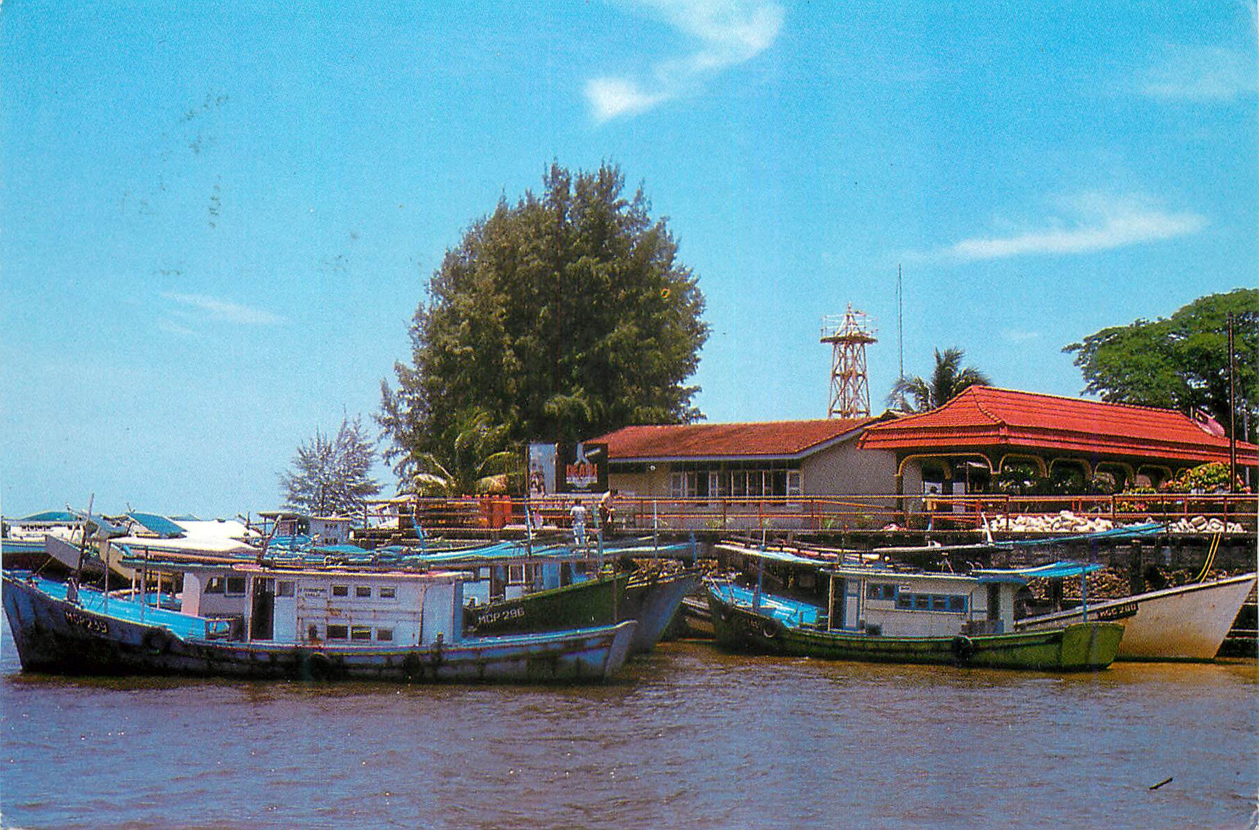 CPM Passenger and fishing boats anchored at the river mouth of Mersing jetty 