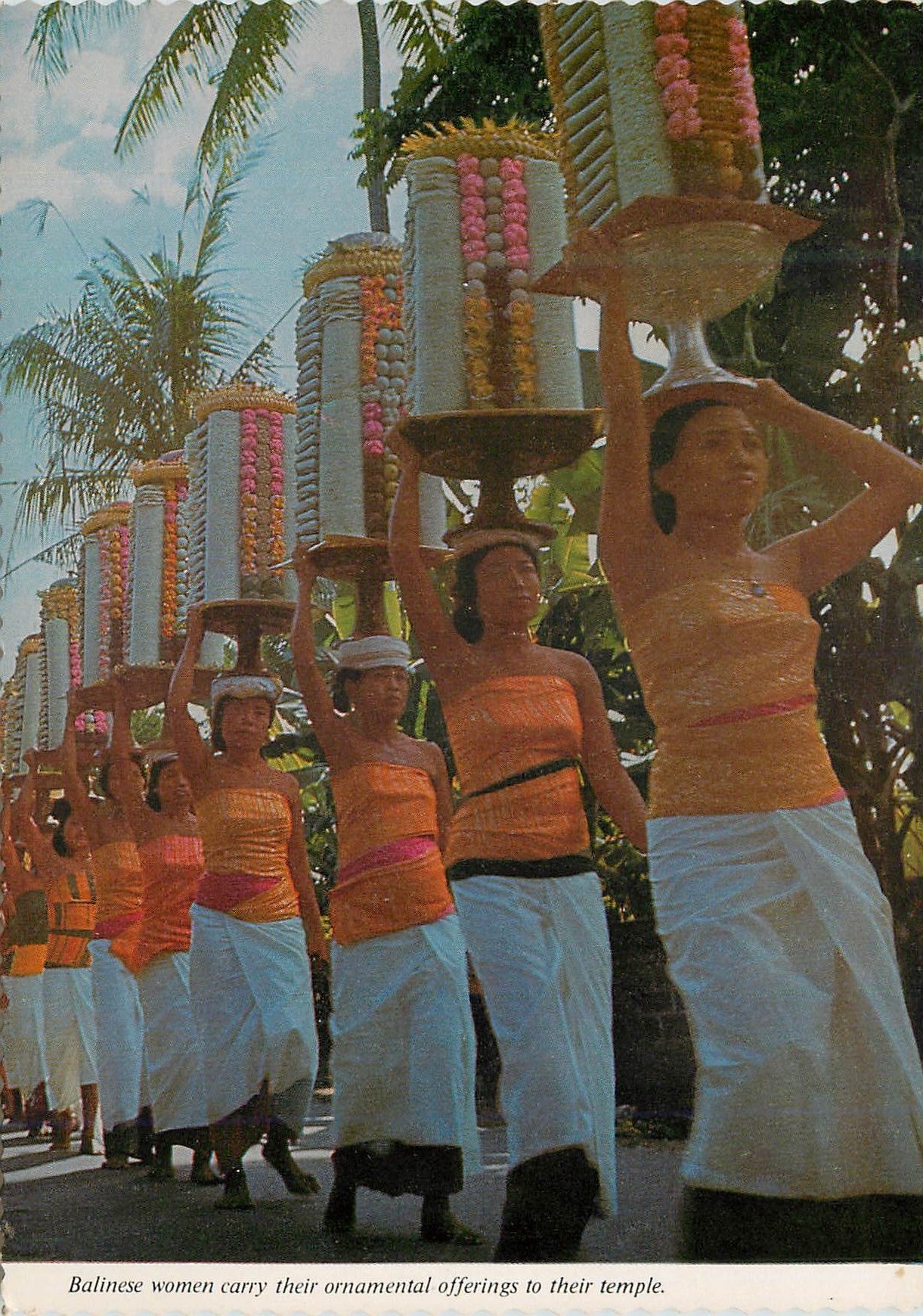CPM Balinese women carry their carry their ornamental offerings to their temple 