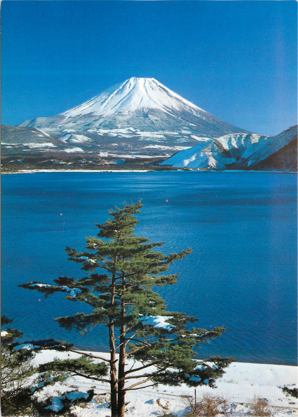 CPM Snow Covered Mt Fuji its Perfect Cone shape Against Blue Skies In the Foreground is Lake Motosu