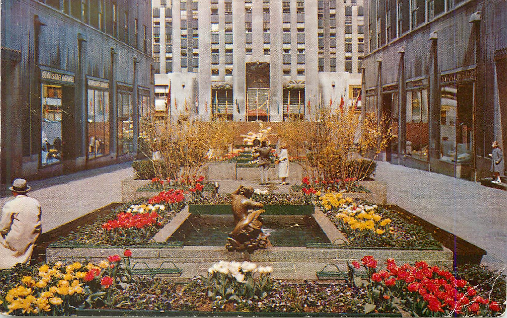 CPM The Channel Gardens Rockefeller Center With Flags of the United Nations in the Background New York City