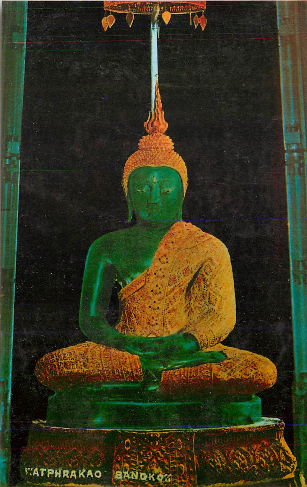 CPM The image of the emerald buddha under rain season attire inside wat pra keo at the royal palace