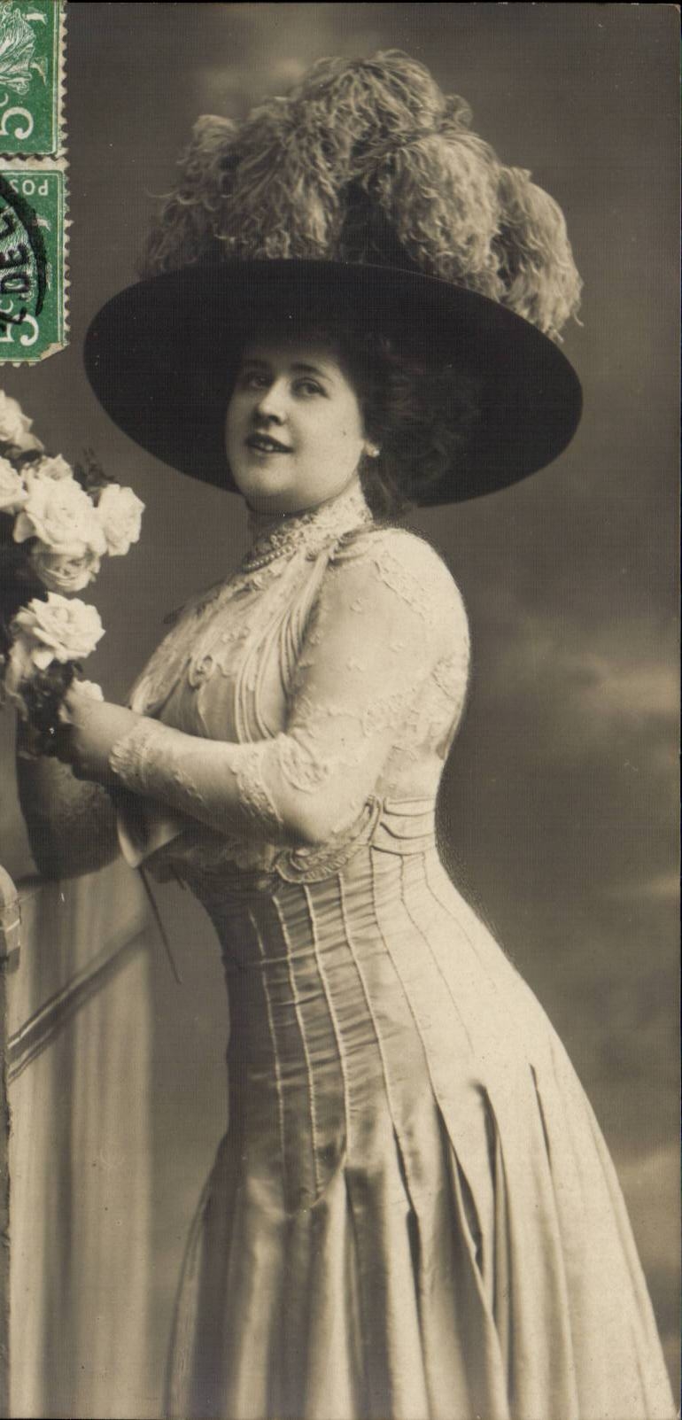 Woman in elegant dress and feathered hat — photograph — unknown publisher