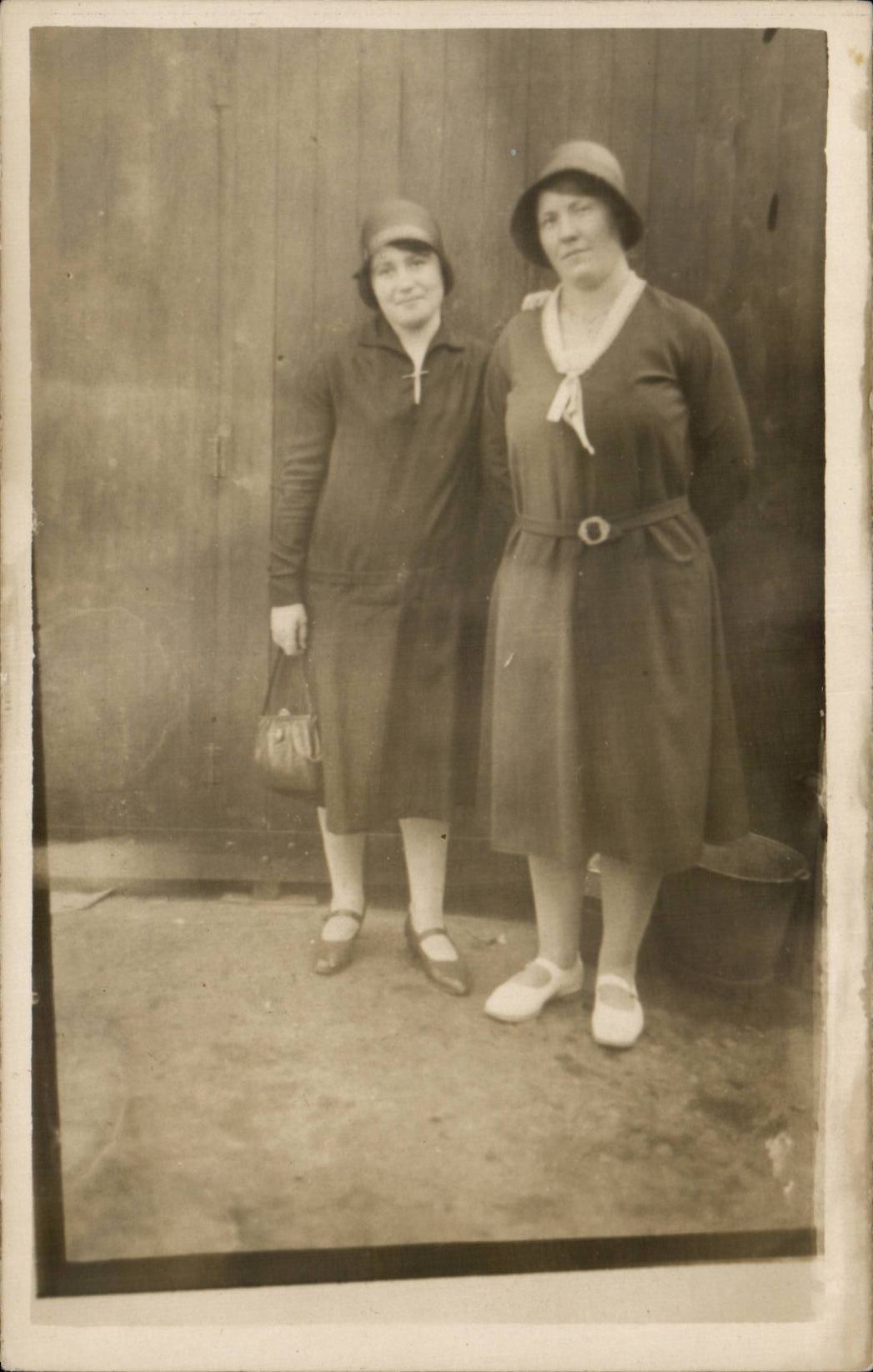 Two women — posing in front of a wooden door — publisher CPAPHIL