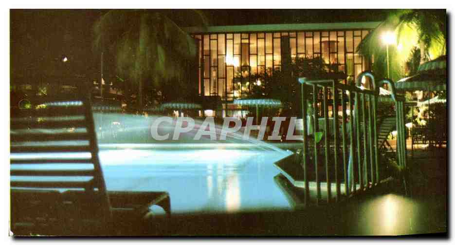 CPA Hilton international Trinidad Pictured at Night With View Of The Swimming Pool And The Pool