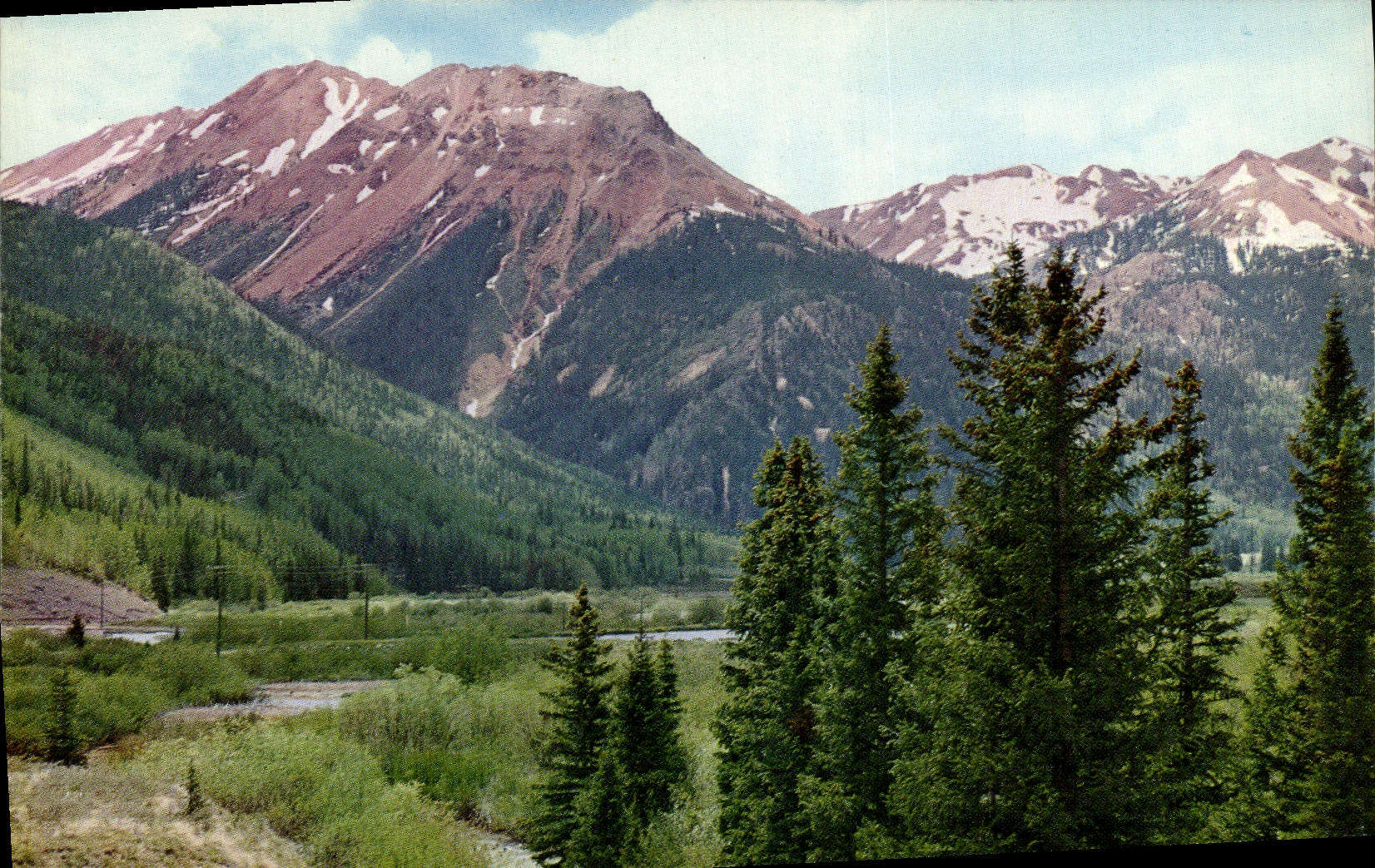 CPM Red Mountains colorful peaks of the san Juan Range which Suddenly loom into sight at Ironton park Colorado