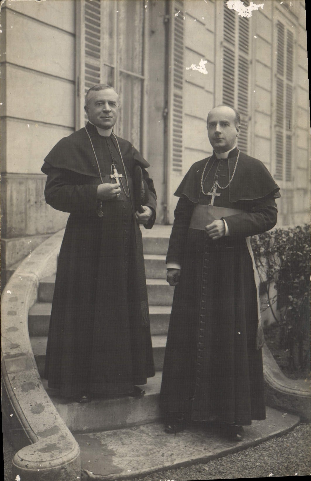 Deux prêtres — devant un bâtiment à volets — Photographie Bertrand