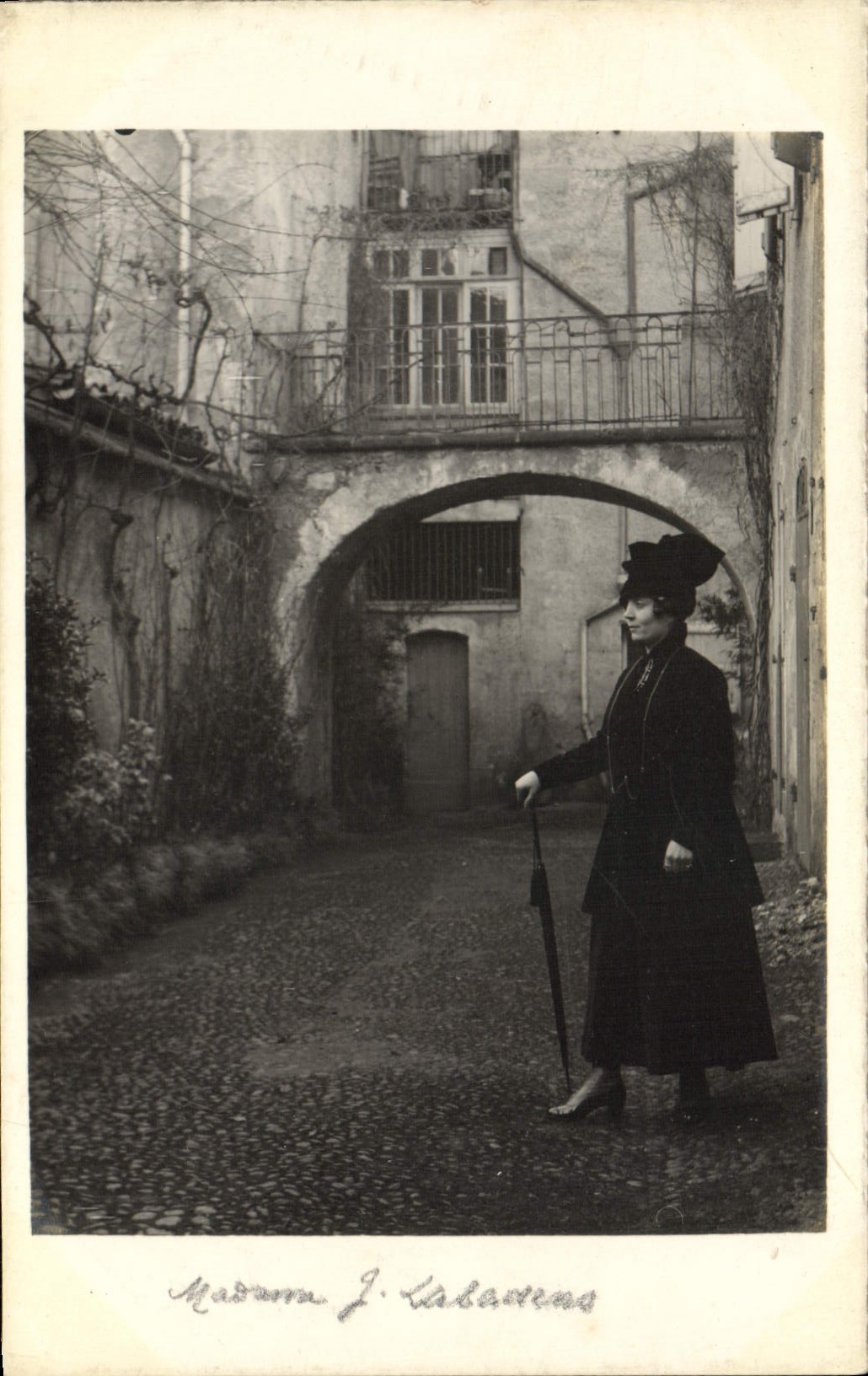 Madame J. Kabadens — portrait dans une cour avec arcade — éditeur inconnu