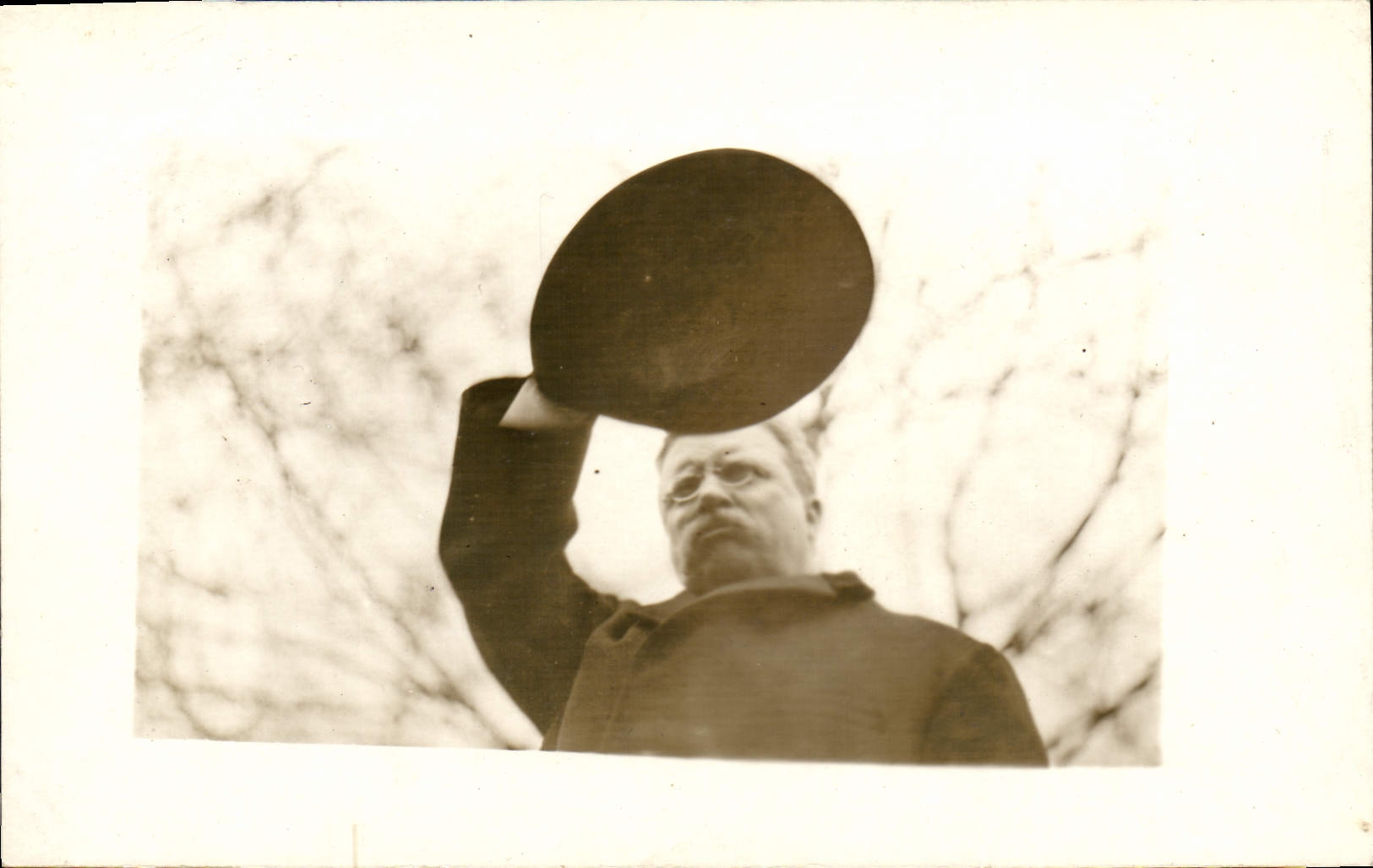 Homme en costume d'époque levant un chapeau — éditeur CPAPHIL, n° de série non visible