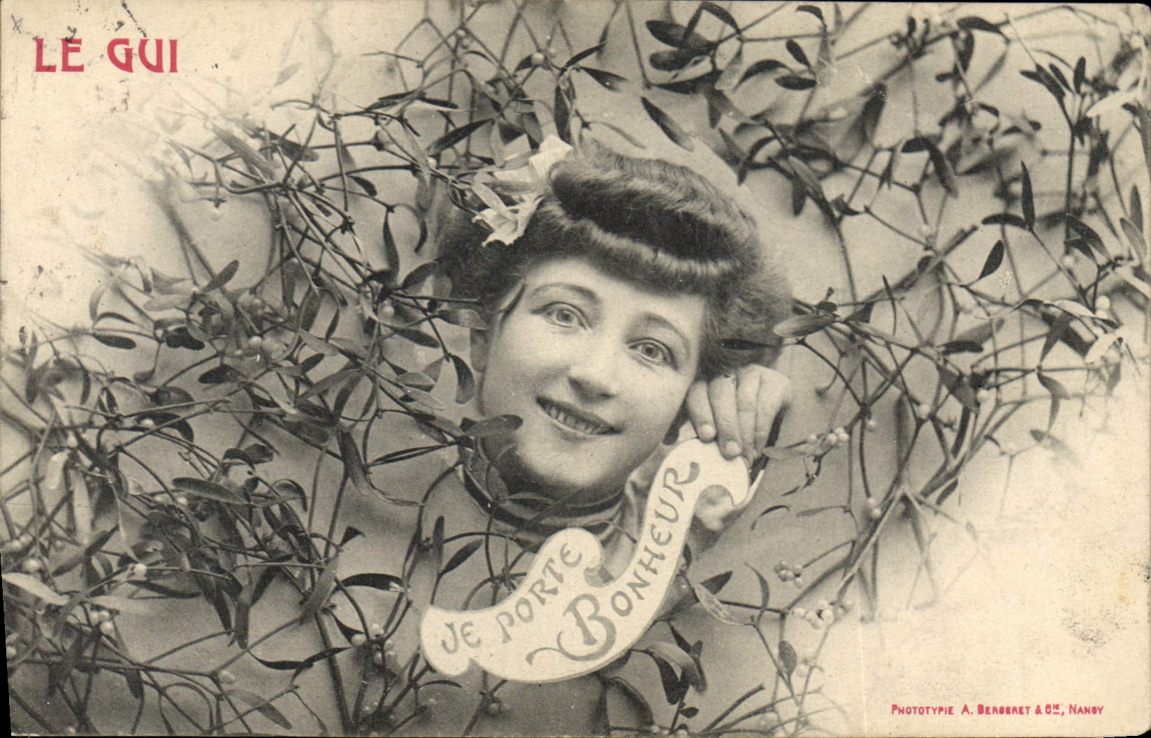 Femme souriante parmi des gui — Phototypie A. Bergeret & Cie, Nancy