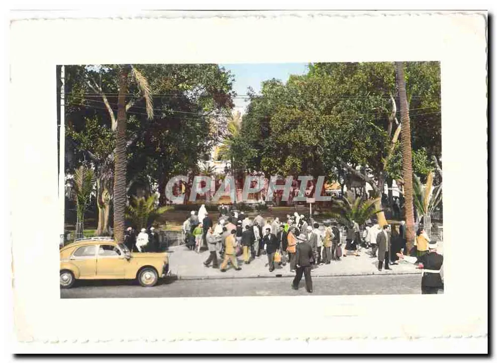 Praça pública arborizada — multidão e carro amarelo — Graphphil - Frente