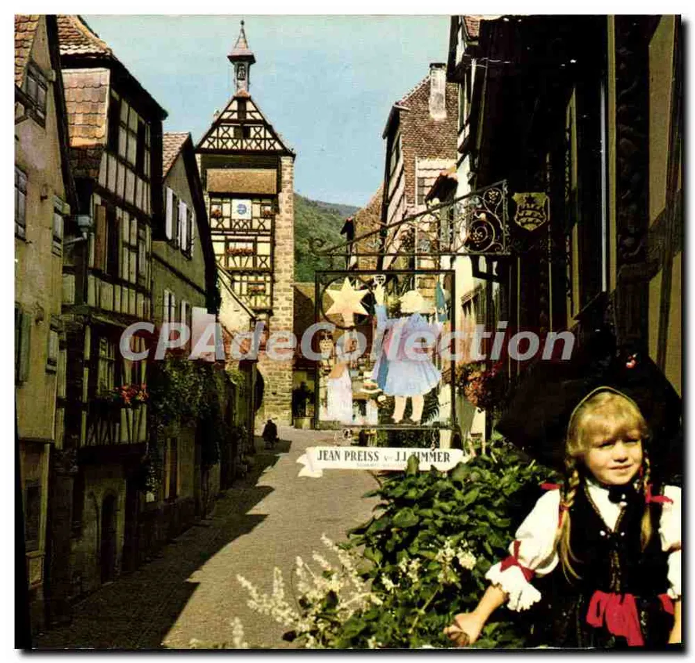 Riquewihr — rue pavée avec tour et vitrine de Jean Preiss — Jean Preiss & JJ Timmer - Recto