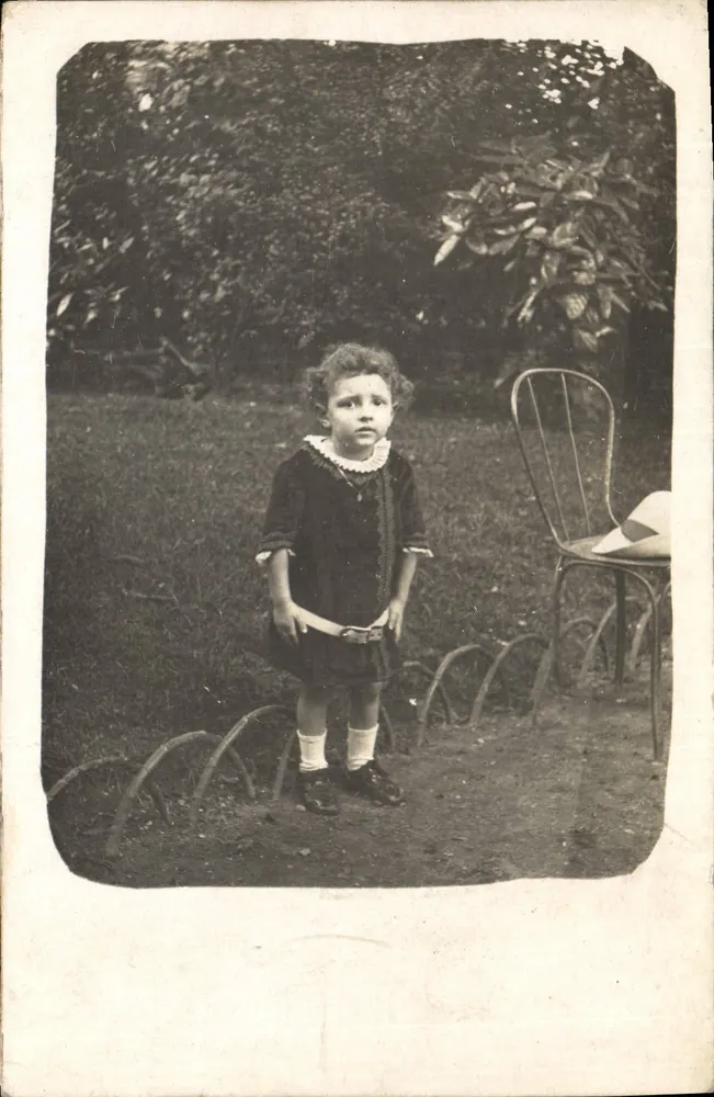Criança no jardim — foto antiga — sem editor ou número visível - Frente
