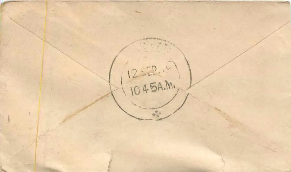 Carta postal indiana — texto em escrita devanagari — selo de ½ anna e carimbo postal de Wilwa - Verso