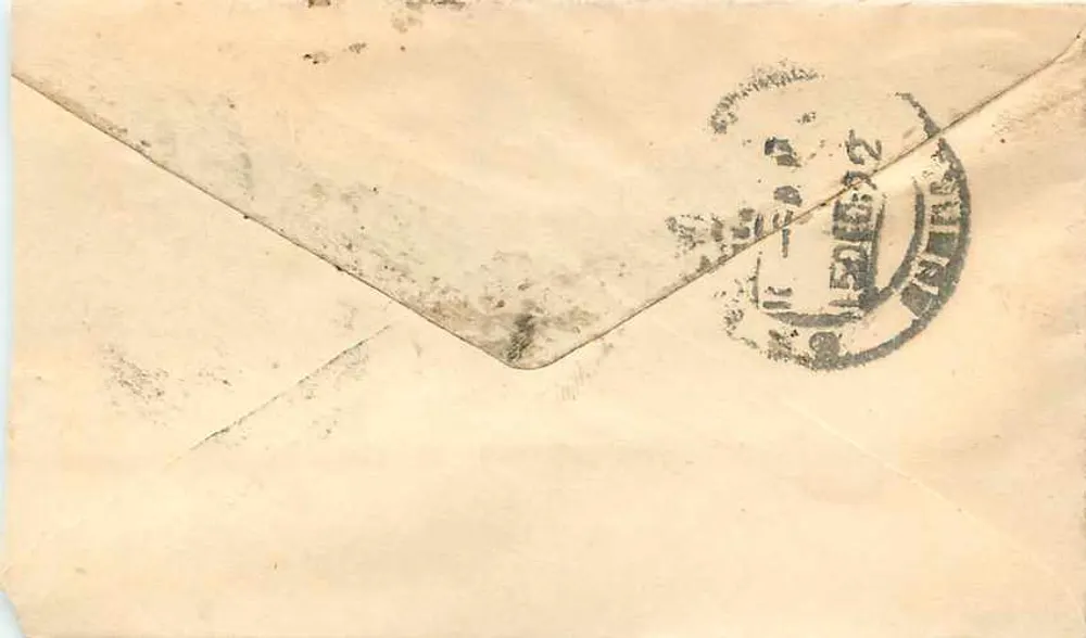 Carta postal indiana — texto em escrita devanagari — selo verde e carimbo postal - Verso