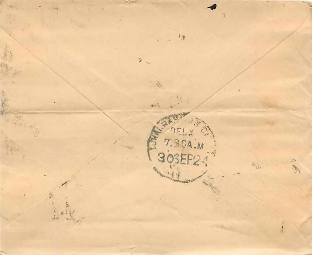 Carta postal indiana — texto em escrita devanagari — selo de um anna e carimbo postal de Delhi - Verso