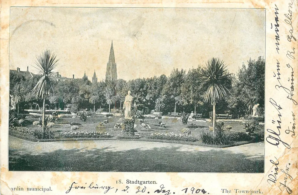 Stadtgarten — parc municipal avec statue et église en arrière-plan — éditeur non identifié, n° 18 - Voorkant