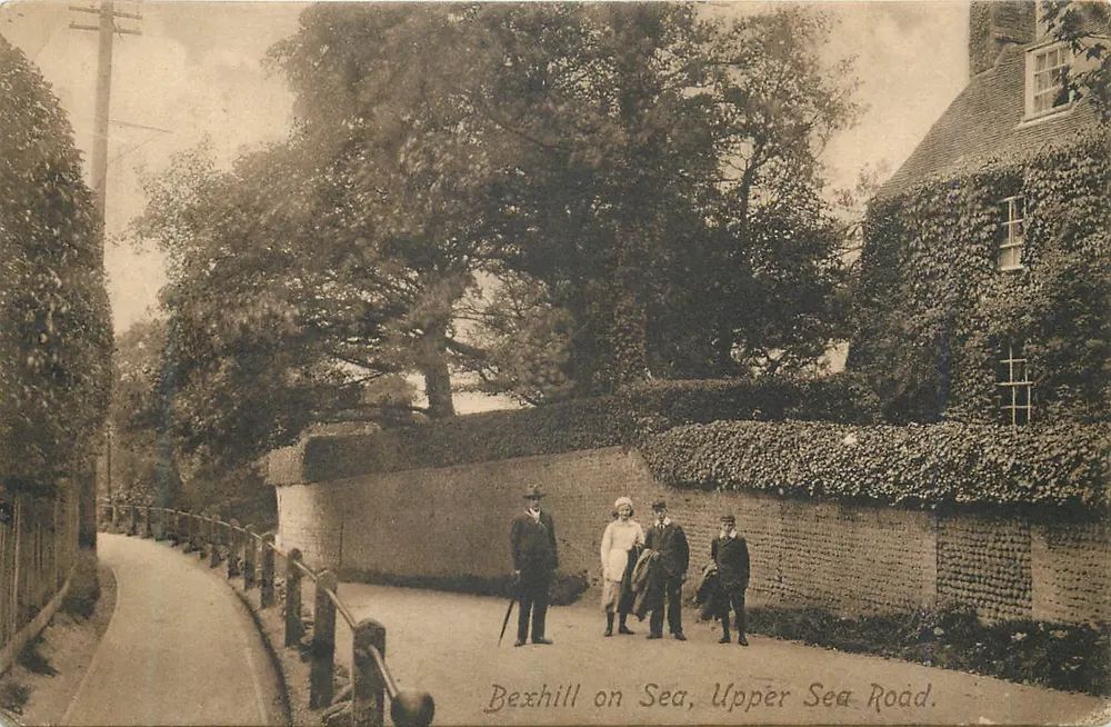 Bexhill on Sea, Upper Sea Road — four people in front of a wall and a ivy-covered building — Frith's Series - Front
