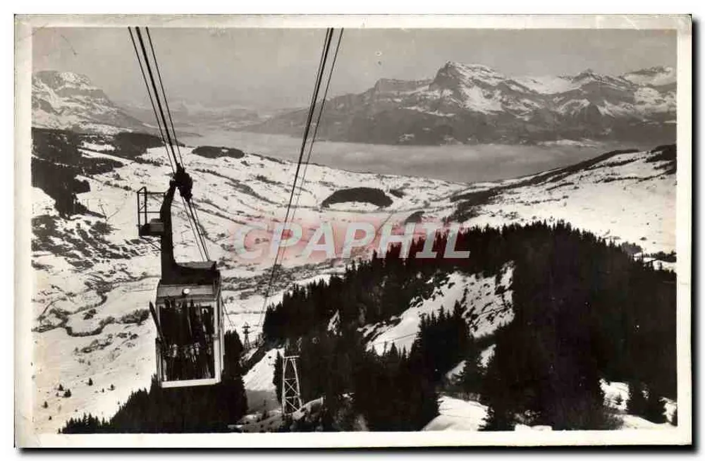 Téléphérique de Mégeve-Rochebrun - Vue depuis la cabine, avec lac et montagnes en arrière-plan — Éditeur : L. MORAND, Photographe, Mégeve - Frente