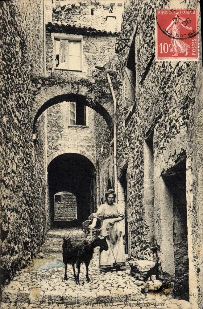 Rue Sainte-Luce — vue de la rue avec une femme et une chèvre — Éditeur : MÉNÉC (Alpes-Maritimes) - Awers