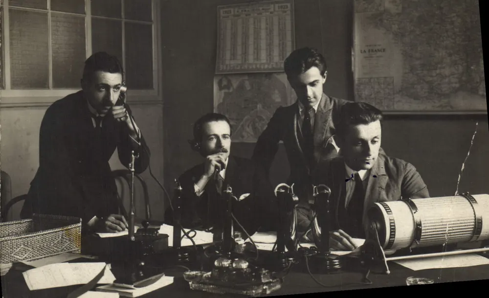 Quatre hommes dans un bureau de télégraphie — équipement radio et calendrier 1923 — éditeur non visible - Vorderseite
