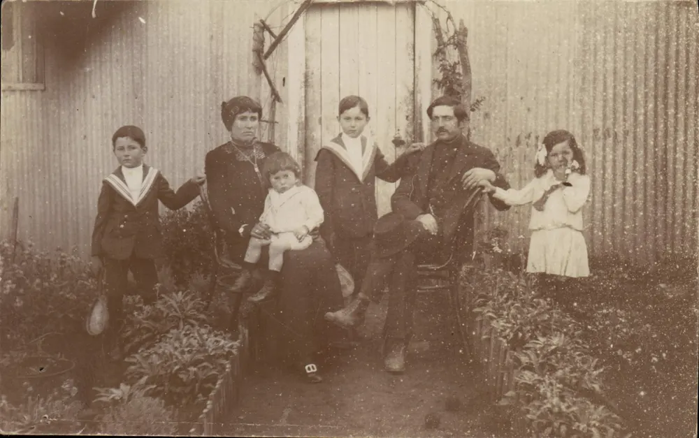 Família diante de uma cerca ondulada — Argentina — Tarjeta Postal Universelle - Frente