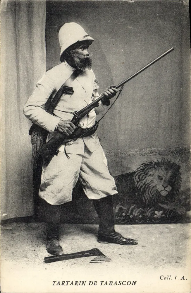 Tartarin de Tarascon — homem em traje de caçador com fuzil e machado, leão em fundo — Coll. I.A. - Frente