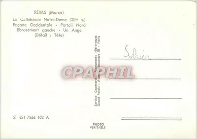 Reims (Marne) — Katedra Najświętszej Panny Marii (XIII w.) — Fałsz zachodni, portal północny, lewy zarys, szczegół: głowa anioła — Wydział Komercyjny Zabytków, Grand Palais, Paryż — Rewers