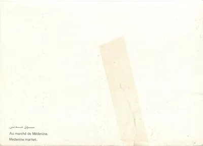 Mercado de Médenine — tapetes e vendedores — sem editor ou número visível — Verso