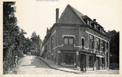 Edifício de tijolos no canto de uma rua pavimentada — Local: Linkebeek — Editor: Petit Coop