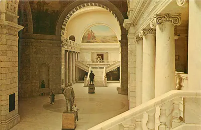 Interior do Museu de Arte de Nova York — vista do hall principal com escadas e estátuas — editor não identificado