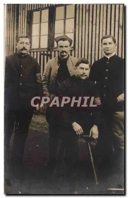 Four men in front of a wooden building — unknown publisher, series number not visible