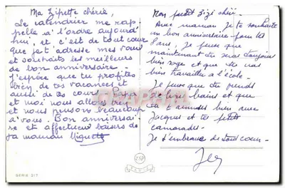 Dwa szczeniaki — czarny i biały — obok małego stawu z żabą — E.J.DE — Rewers